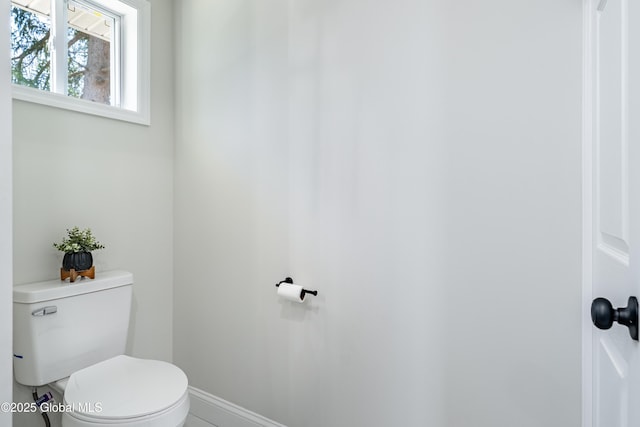 bathroom featuring toilet and baseboards