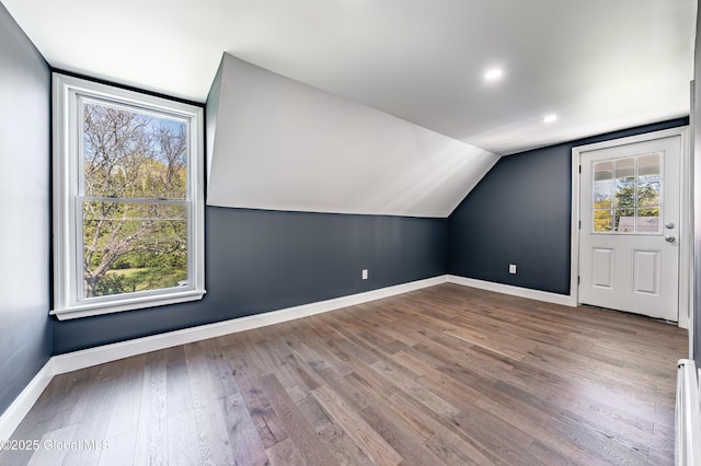 bonus room featuring wood finished floors, recessed lighting, vaulted ceiling, and baseboards