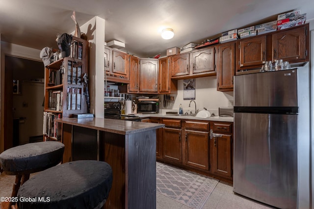 192 Broadway, Fort Edward, NY 12828 - kitchen with under cabinet range hood, stainless steel appliances, a peninsula, and a sink