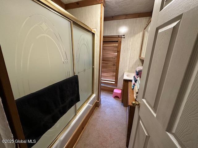 full bath with wooden walls, an enclosed shower, and vanity