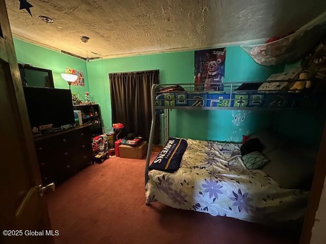 bedroom featuring carpet floors and a textured ceiling