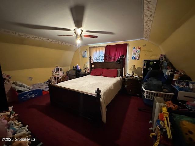bedroom featuring vaulted ceiling, a ceiling fan, and carpet floors
