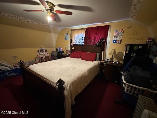 bedroom featuring ceiling fan and vaulted ceiling