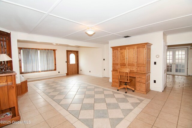 entryway featuring baseboards, french doors, and light tile patterned flooring