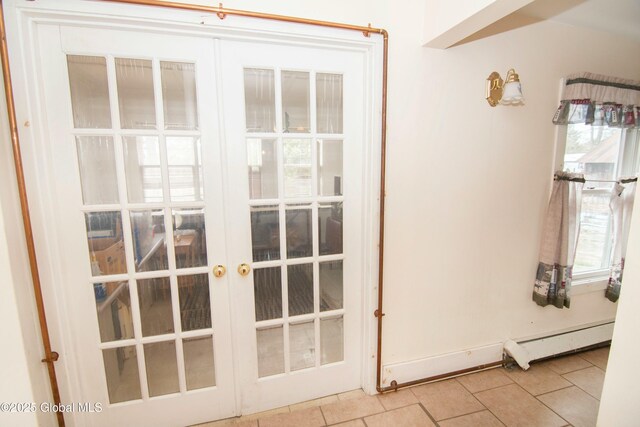 doorway featuring french doors, a baseboard heating unit, and tile patterned floors