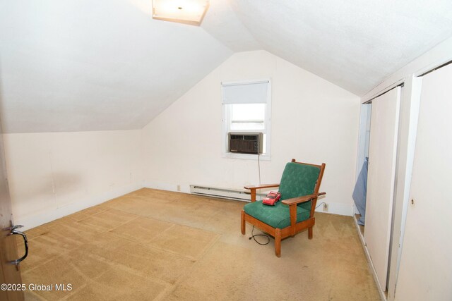 sitting room featuring carpet floors, lofted ceiling, baseboard heating, and cooling unit
