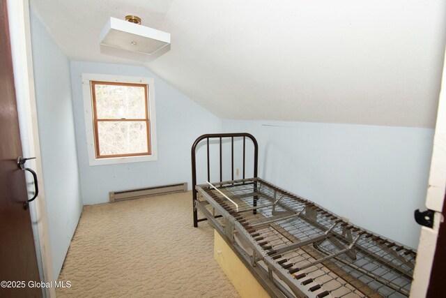 unfurnished bedroom featuring baseboard heating, carpet flooring, and lofted ceiling