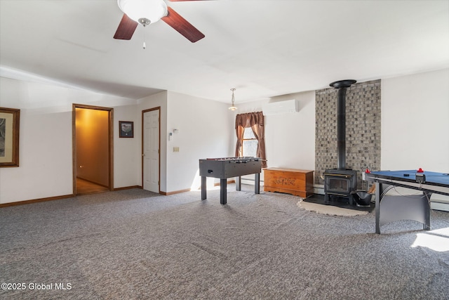 230 Zicha Rd, Esperance, NY 12092 - rec room with ceiling fan, a wall mounted AC, a wood stove, baseboards, and carpet flooring