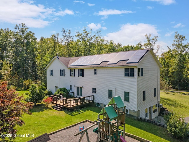 230 Zicha Rd, Esperance, NY 12092 - rear view of property featuring a lawn, solar panels, a playground, and a wooden deck
