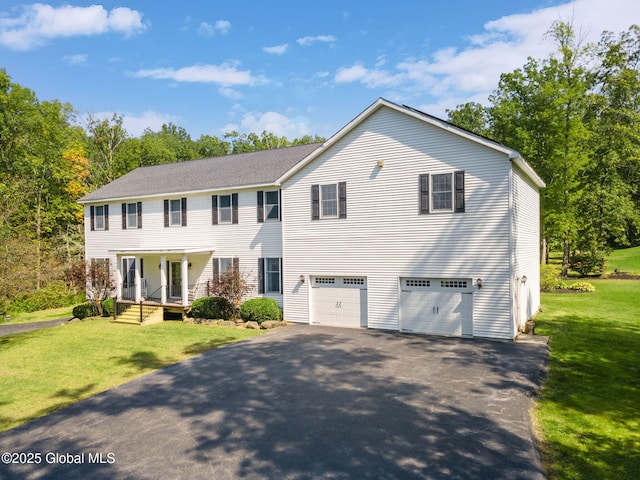 230 Zicha Rd, Esperance, NY 12092 - colonial house featuring a porch, an attached garage, a front lawn, and aphalt driveway
