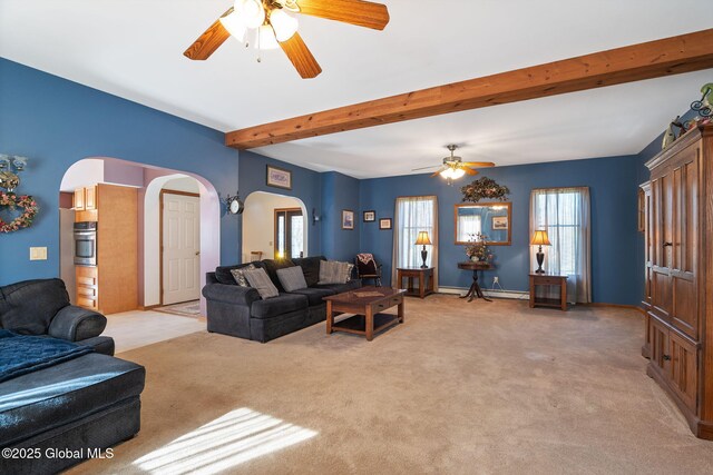 230 Zicha Rd, Esperance, NY 12092 - living area featuring light carpet, beamed ceiling, baseboards, ceiling fan, and arched walkways