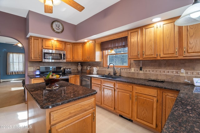 230 Zicha Rd, Esperance, NY 12092 - kitchen with baseboard heating, a sink, dark stone countertops, stainless steel appliances, and a ceiling fan