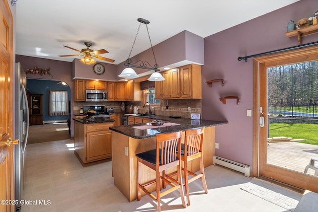 230 Zicha Rd, Esperance, NY 12092 - kitchen featuring decorative backsplash, lofted ceiling, a baseboard heating unit, a sink, and stainless steel appliances