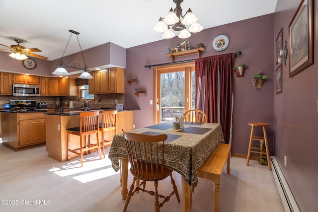 230 Zicha Rd, Esperance, NY 12092 - dining room with ceiling fan with notable chandelier, light floors, a baseboard heating unit, and a healthy amount of sunlight