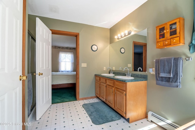230 Zicha Rd, Esperance, NY 12092 - bathroom featuring a sink, ensuite bath, double vanity, tile patterned floors, and a baseboard heating unit