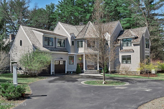 1 Joshua Rd, Saratoga Springs, NY 12866 - shingle-style home featuring a garage, central air condition unit, driveway, and roof with shingles