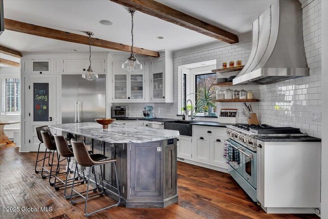 1 Joshua Rd, Saratoga Springs, NY 12866 - kitchen featuring wall chimney range hood, tasteful backsplash, premium appliances, a sink, and beamed ceiling