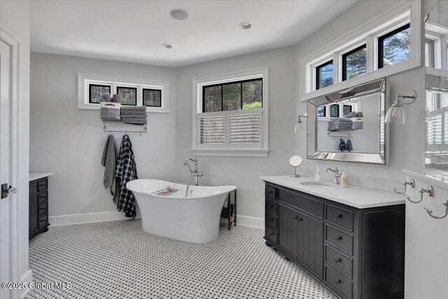 1 Joshua Rd, Saratoga Springs, NY 12866 - full bathroom featuring baseboards, a freestanding tub, and vanity