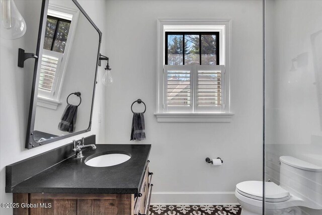 1 Joshua Rd, Saratoga Springs, NY 12866 - bathroom with baseboards, a wealth of natural light, toilet, and vanity