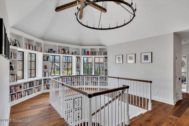 1 Joshua Rd, Saratoga Springs, NY 12866 - hallway with vaulted ceiling, wood finished floors, an upstairs landing, built in features, and stacked washer and clothes dryer