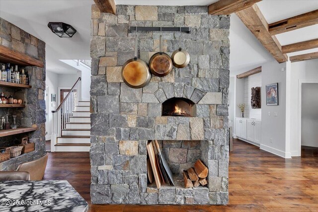 1 Joshua Rd, Saratoga Springs, NY 12866 - living area featuring beam ceiling, wood finished floors, a stone fireplace, and baseboards
