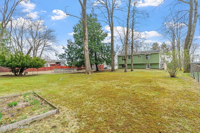 view of yard with fence and a vegetable garden