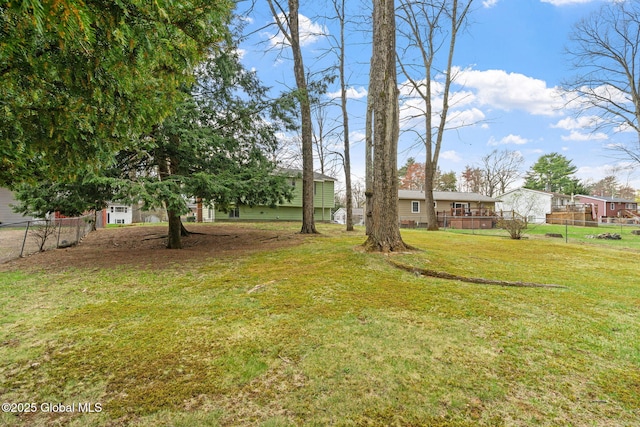view of yard featuring a deck and fence