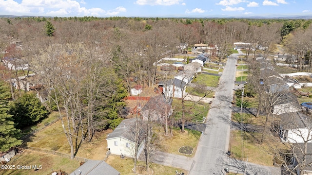 drone / aerial view featuring a forest view and a residential view