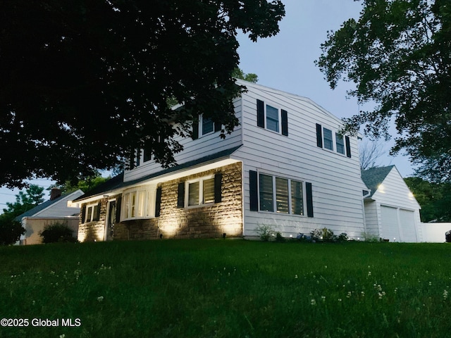 1094 Deforest St, Rotterdam, NY 12303 - view of front of house with stone siding, a garage, and a front yard