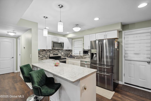 1094 Deforest St, Rotterdam, NY 12303 - kitchen with appliances with stainless steel finishes, a sink, a peninsula, white cabinetry, and recessed lighting