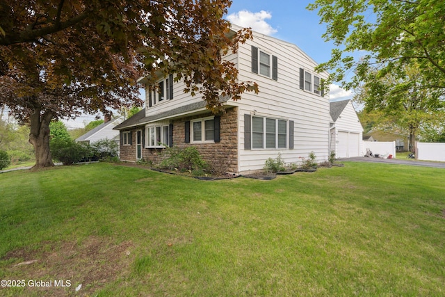 1094 Deforest St, Rotterdam, NY 12303 - view of front of house featuring driveway, an attached garage, a front lawn, and stone siding