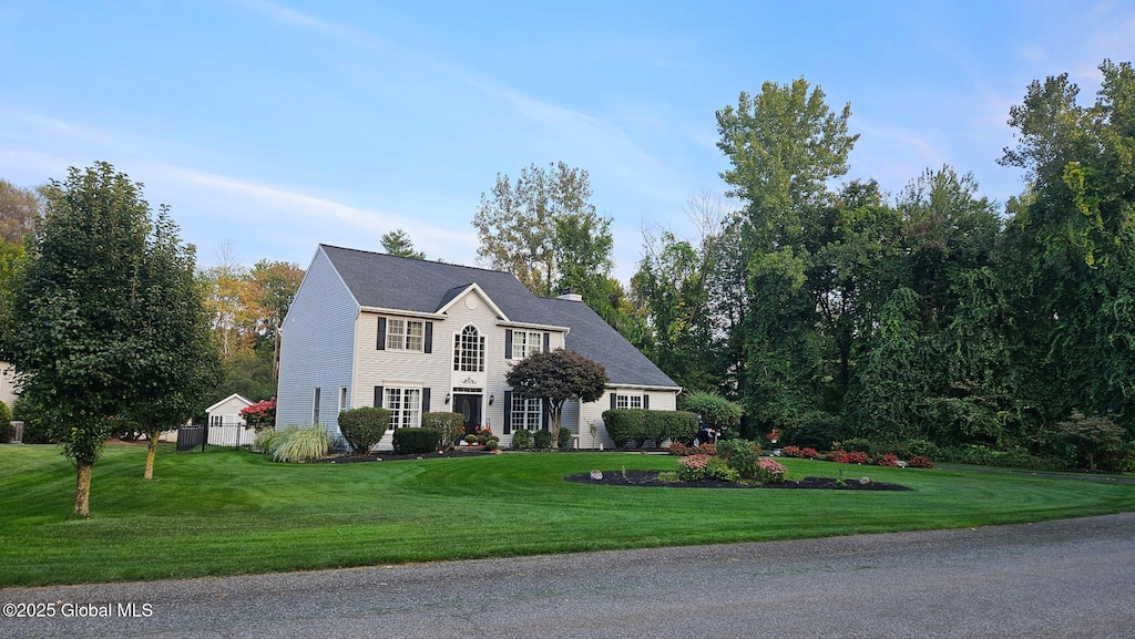 33 Spice Mill Blvd, Halfmoon, NY 12065 - colonial house featuring a chimney and a front lawn
