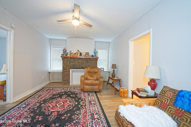 1823 8th St, Rensselaer, NY 12144 - living room featuring radiator, baseboards, a ceiling fan, and wood finished floors