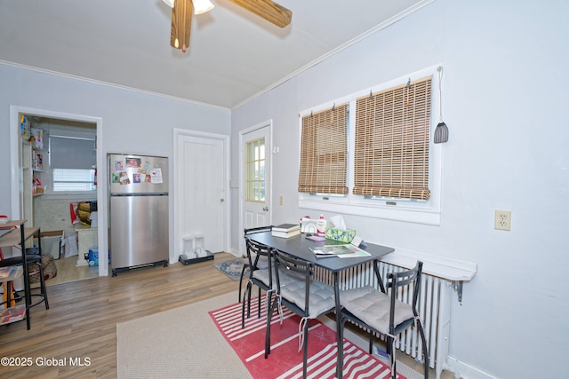 1823 8th St, Rensselaer, NY 12144 - dining room featuring baseboards, a ceiling fan, wood finished floors, and crown molding
