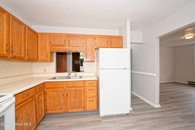 1823 8th St, Rensselaer, NY 12144 - kitchen with a sink, light wood-type flooring, freestanding refrigerator, brown cabinetry, and light countertops