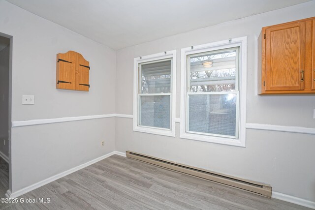 1823 8th St, Rensselaer, NY 12144 - empty room with baseboard heating, baseboards, and wood finished floors