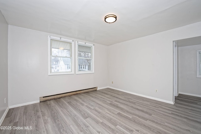 1823 8th St, Rensselaer, NY 12144 - spare room featuring a baseboard radiator, wood finished floors, and baseboards