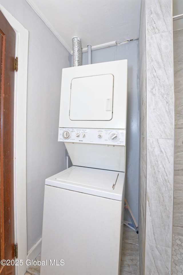 1823 8th St, Rensselaer, NY 12144 - laundry room with stacked washer / drying machine, baseboards, ornamental molding, and laundry area