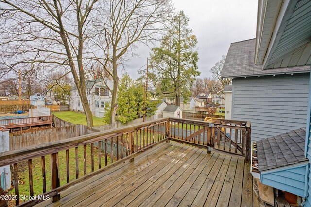 1823 8th St, Rensselaer, NY 12144 - wooden terrace featuring a residential view, a fenced backyard, a storage unit, and an outbuilding