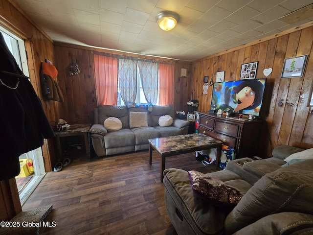living room with wood finished floors and wood walls