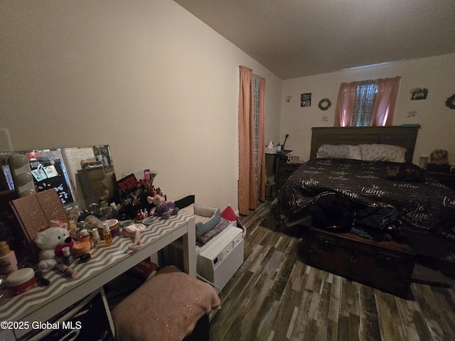 bedroom featuring lofted ceiling and wood finished floors