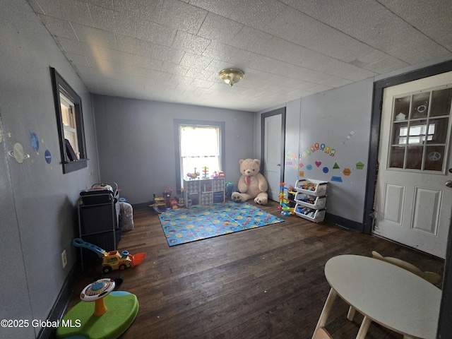 game room with baseboards and hardwood / wood-style flooring