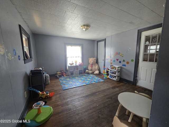 rec room featuring baseboards and wood finished floors