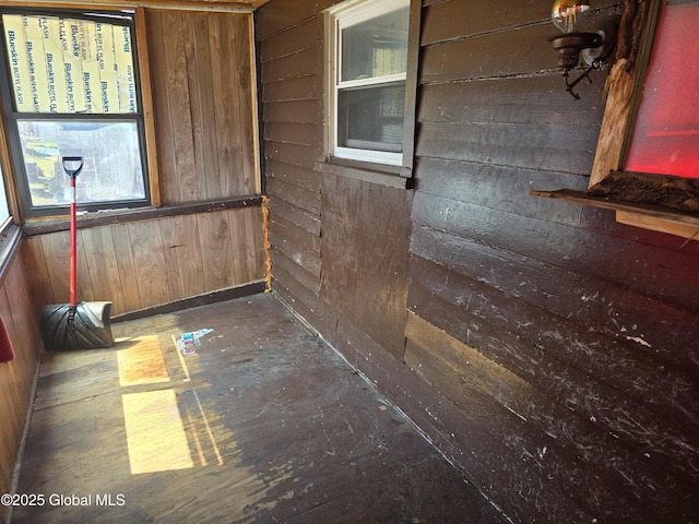 unfurnished room with wood walls