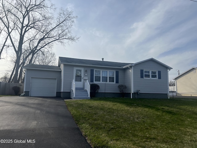 ranch-style house featuring an attached garage, a front lawn, driveway, and fence