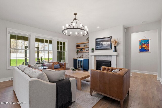 6 Gorsline Dr, Halfmoon, NY 12118 - living room featuring hardwood / wood-style floors, baseboards, and a notable chandelier