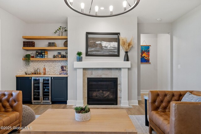 6 Gorsline Dr, Halfmoon, NY 12118 - living room with light wood-type flooring, a dry bar, beverage cooler, and a fireplace