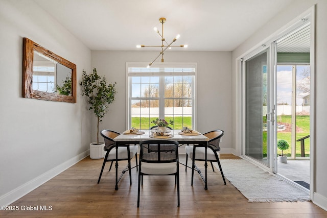 6 Gorsline Dr, Halfmoon, NY 12118 - dining space featuring plenty of natural light, wood finished floors, and an inviting chandelier