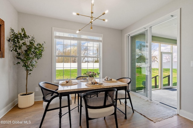 6 Gorsline Dr, Halfmoon, NY 12118 - dining area with wood finished floors, baseboards, and a notable chandelier