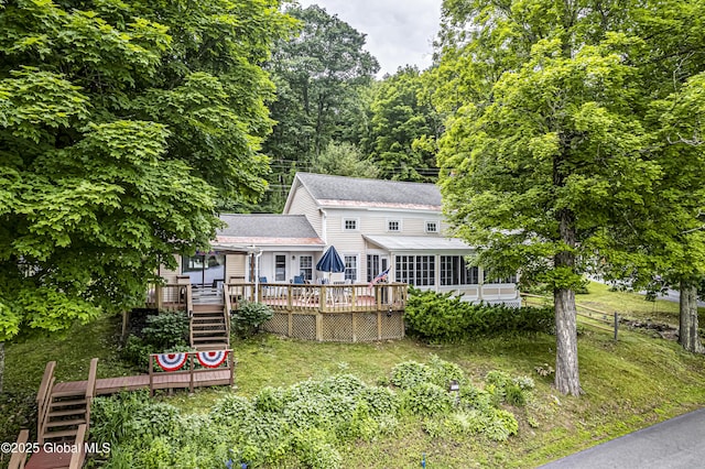 back of house with a shingled roof, stairs, and a deck
